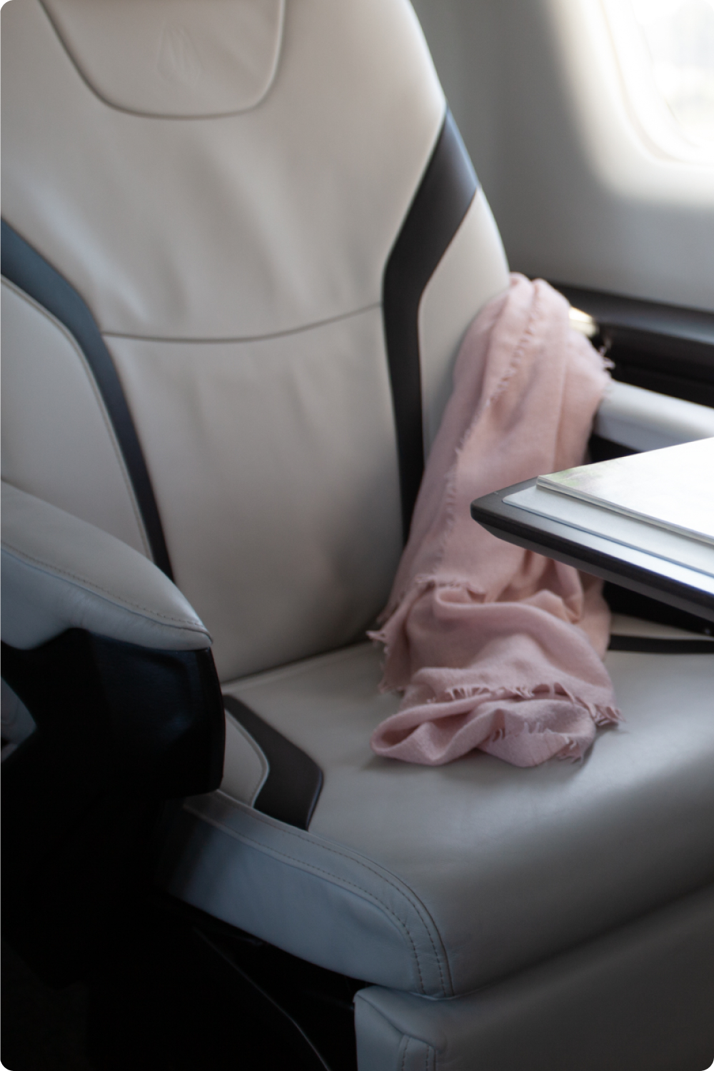 Leather cabin seat with a blanket and fold-out table