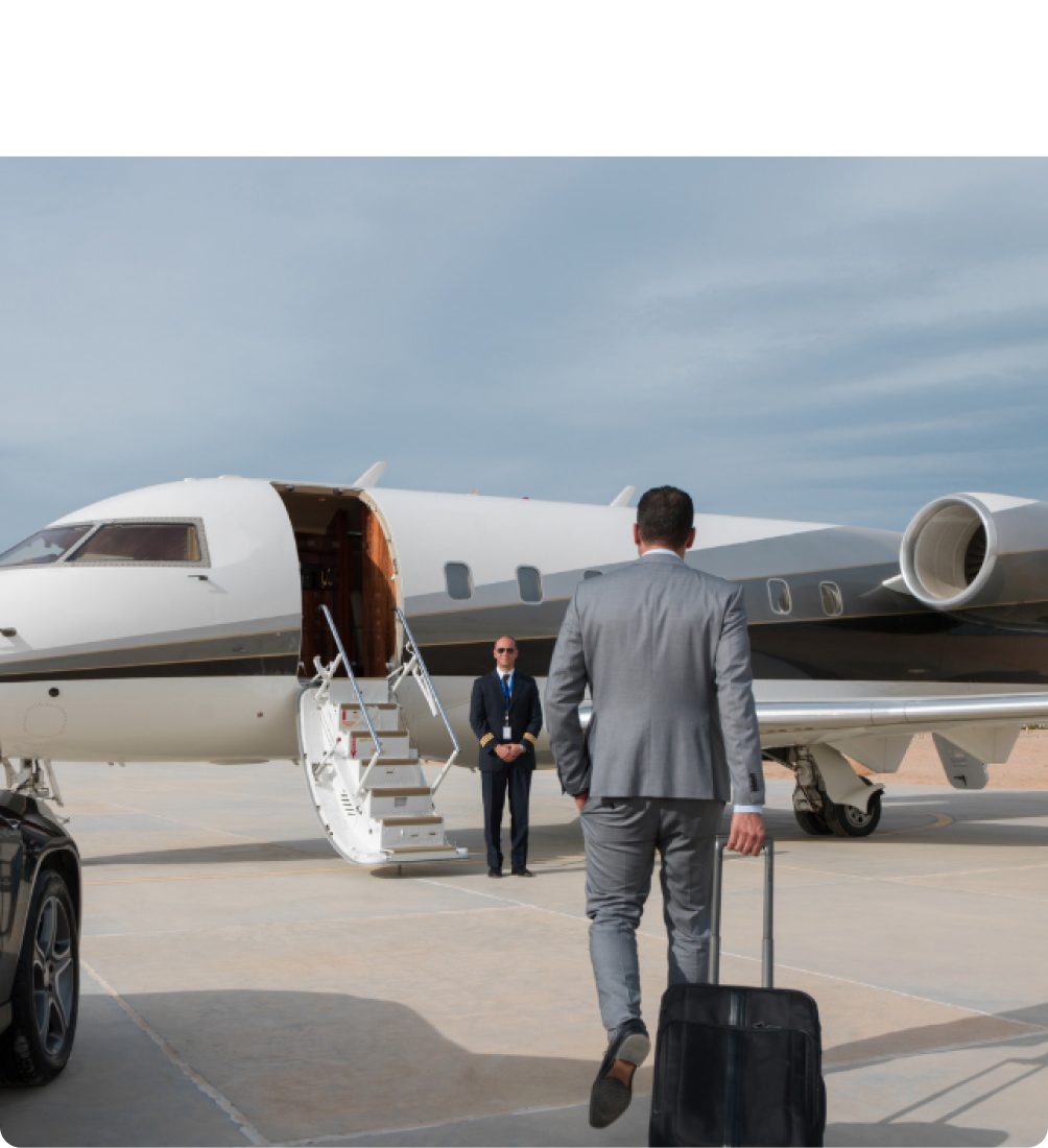 Executive walking to a business jet with luggage